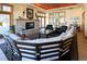 A well-furnished lounge area with a stone fireplace, comfortable seating, and plenty of natural light through large windows at 13708 Legend Trl # 101, Broomfield, CO 80023