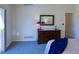 Main bedroom featuring natural lighting, carpeted floors, and a dark wood dresser at 13708 Legend Trl # 101, Broomfield, CO 80023