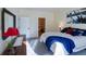 Bright main bedroom featuring natural lighting, a carpeted floor, and access to the ensuite bath at 13708 Legend Trl # 101, Broomfield, CO 80023