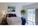 Bright main bedroom featuring a sliding glass door and a walk-in closet at 13708 Legend Trl # 101, Broomfield, CO 80023
