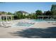 Outdoor community pool with a shallow wading pool surrounded by lounge chairs, picnic tables, and a pergola at 13708 Legend Trl # 101, Broomfield, CO 80023