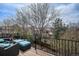 Back deck with seating overlooking the surrounding trees and neighborhood at 9195 Anasazi Indian Trl, Highlands Ranch, CO 80129