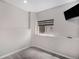 Neutral finished basement space with gray carpet, a window, and a mounted television at 9195 Anasazi Indian Trl, Highlands Ranch, CO 80129