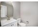 Stylish powder room featuring updated fixtures and a decorative mirror, blending functionality with modern design at 9195 Anasazi Indian Trl, Highlands Ranch, CO 80129