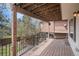 Inviting covered deck with string lights and black metal railings offers a cozy outdoor space at 9195 Anasazi Indian Trl, Highlands Ranch, CO 80129