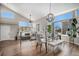 Open dining area with modern lighting, large windows, and seamless access to the living room at 9195 Anasazi Indian Trl, Highlands Ranch, CO 80129