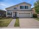 Charming two-story home featuring a well-manicured front yard and attached two car garage at 9195 Anasazi Indian Trl, Highlands Ranch, CO 80129