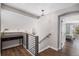 Open landing with stylish decor, wood floors, and staircase, offering a seamless transition between levels at 9195 Anasazi Indian Trl, Highlands Ranch, CO 80129