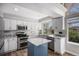Beautiful kitchen with stainless steel appliances, white cabinets, and a contrasting blue island at 9195 Anasazi Indian Trl, Highlands Ranch, CO 80129