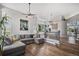 Bright living room featuring a large sectional sofa, high ceilings, and hardwood floors at 9195 Anasazi Indian Trl, Highlands Ranch, CO 80129