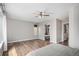 Spacious main bedroom with an adjoining spa-like bathroom, featuring wood floors and ample natural light at 9195 Anasazi Indian Trl, Highlands Ranch, CO 80129