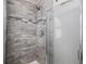 Modern shower featuring stylish tile work, a glass door, and updated fixtures, providing a spa-like experience at 9195 Anasazi Indian Trl, Highlands Ranch, CO 80129