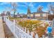 House exterior showcasing a well-maintained lawn and white picket fence at 7051 Grape St, Commerce City, CO 80022