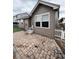 Inviting brick patio with artificial turf and white fence offering a private outdoor space at 1137 S Coolidge Cir, Aurora, CO 80018