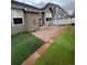 Cozy brick patio area in backyard with artificial turf, great for entertaining and relaxation at 1137 S Coolidge Cir, Aurora, CO 80018