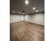 Finished basement with wood-look flooring, recessed lighting and gray painted walls at 1137 S Coolidge Cir, Aurora, CO 80018