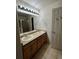 Bathroom with double sink vanity and large mirror with modern lighting fixture at 1137 S Coolidge Cir, Aurora, CO 80018