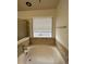 Bathroom featuring a soaking tub with a window that brings in natural light at 1137 S Coolidge Cir, Aurora, CO 80018