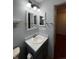 Well-lit bathroom with single sink vanity and decorative mirrors at 1137 S Coolidge Cir, Aurora, CO 80018
