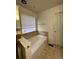 Bathroom featuring a soaking tub with a window that brings in natural light at 1137 S Coolidge Cir, Aurora, CO 80018
