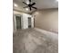 Large primary bedroom featuring ceiling fan, carpet, and archway to ensuite bath at 1137 S Coolidge Cir, Aurora, CO 80018
