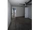 Carpeted bedroom features gray walls, ceiling fan and doorway leading to hallway at 1137 S Coolidge Cir, Aurora, CO 80018