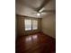 Bedroom with hardwood floors, ceiling fan, and large window providing natural light at 1137 S Coolidge Cir, Aurora, CO 80018
