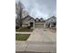 Charming two-story home featuring a brick-accented garage and well-maintained front yard with mature tree at 1137 S Coolidge Cir, Aurora, CO 80018