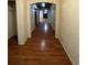 Hallway featuring beautiful wood floors and an arched doorway leading to living space at 1137 S Coolidge Cir, Aurora, CO 80018