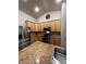 Kitchen featuring stainless steel appliances, oak cabinetry, and granite countertops at 1137 S Coolidge Cir, Aurora, CO 80018