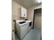 Convenient laundry room with washer, dryer, storage cabinets and decorative floor at 1137 S Coolidge Cir, Aurora, CO 80018