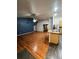 Open concept living area featuring kitchen island and wood-look flooring at 1137 S Coolidge Cir, Aurora, CO 80018