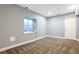 Finished basement with carpet and neutral-colored walls, with a window and a door at 7426 Blue Water Ln, Castle Rock, CO 80108