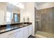 Bathroom with granite countertops, white cabinets, and a glass-enclosed shower at 7426 Blue Water Ln, Castle Rock, CO 80108