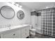 Bright bathroom featuring a dual sink vanity, modern fixtures, and tiled shower and tub at 7426 Blue Water Ln, Castle Rock, CO 80108