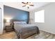 Comfortable bedroom with a gray color scheme, featuring a decorative ceiling fan and wood-look floors at 7426 Blue Water Ln, Castle Rock, CO 80108