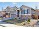 Beautiful gray single-Gathering home with stone veneer, two-car garage, and well-maintained lawn at 7426 Blue Water Ln, Castle Rock, CO 80108