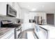 Well-lit kitchen featuring stainless steel appliances, granite countertops, and plenty of cabinet space at 7426 Blue Water Ln, Castle Rock, CO 80108