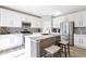 Modern kitchen with white cabinets, stainless steel appliances, granite countertops, and a kitchen island at 7426 Blue Water Ln, Castle Rock, CO 80108