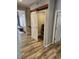 Hallway with a sliding barn door that leads into a laundry room area with modern washer and dryer at 7426 Blue Water Ln, Castle Rock, CO 80108