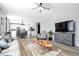 Inviting open concept living room with hardwood floors and a view of the dining area and kitchen at 7426 Blue Water Ln, Castle Rock, CO 80108