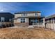 Exterior view of a home's backyard featuring a cozy porch and grassy yard on a sunny day at 17046 Desert Wine Trl, Parker, CO 80134