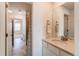 Bright bathroom featuring marble floors, bathtub and a large mirror that reflects an open doorway into an adjacent bedroom at 17046 Desert Wine Trl, Parker, CO 80134