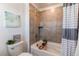 Well-lit bathroom featuring tiled bathtub with shower and modern fixtures at 17046 Desert Wine Trl, Parker, CO 80134