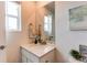 Stylish half-bathroom with a mirror above the sink and a decorative flower pot at 17046 Desert Wine Trl, Parker, CO 80134