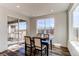 Well lit dining room with hardwood floors and a modern table set next to sliding glass doors at 17046 Desert Wine Trl, Parker, CO 80134