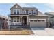 Charming two-story home with a covered porch, two-car garage, and well-maintained landscaping at 17046 Desert Wine Trl, Parker, CO 80134