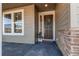 Inviting front door with a wreath, side window, and stone accents create a warm welcome at 17046 Desert Wine Trl, Parker, CO 80134