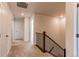 Neutral-toned upstairs hallway with carpet flooring, white walls, and a dark wooden stair railing at 17046 Desert Wine Trl, Parker, CO 80134