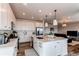 Bright kitchen with a center island, white cabinets, stainless steel appliances and hardwood floors at 17046 Desert Wine Trl, Parker, CO 80134